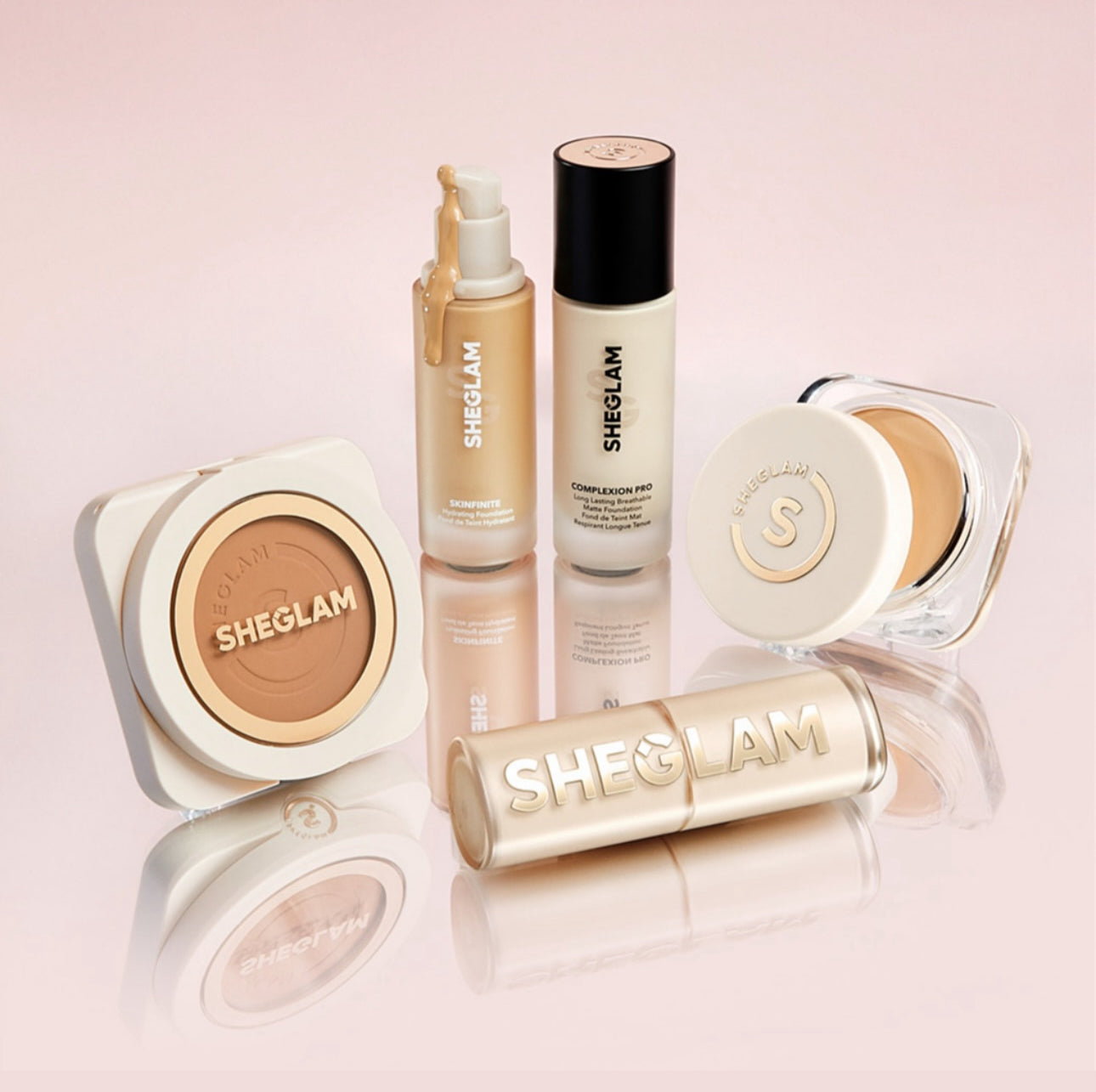 Slide imageA studio-style photograph featuring a full SHEGLAM makeup set including foundation, concealer, compact powder, and setting spray, all displayed on a glossy soft pink background. The arrangement highlights the brand’s sleek packaging and elegant aesthetic, perfect for showcasing long-lasting, high-performance makeup essentials.