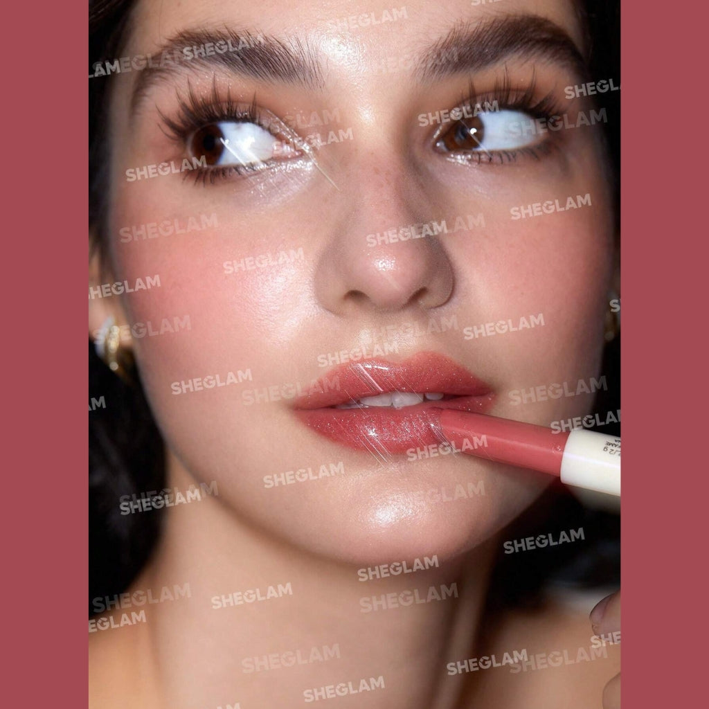 SHEGLAM Pout-Perfect Shimmer Lip Plumper in Pink Flamingo, solid pink glitter lip gloss stick on a clean background.
