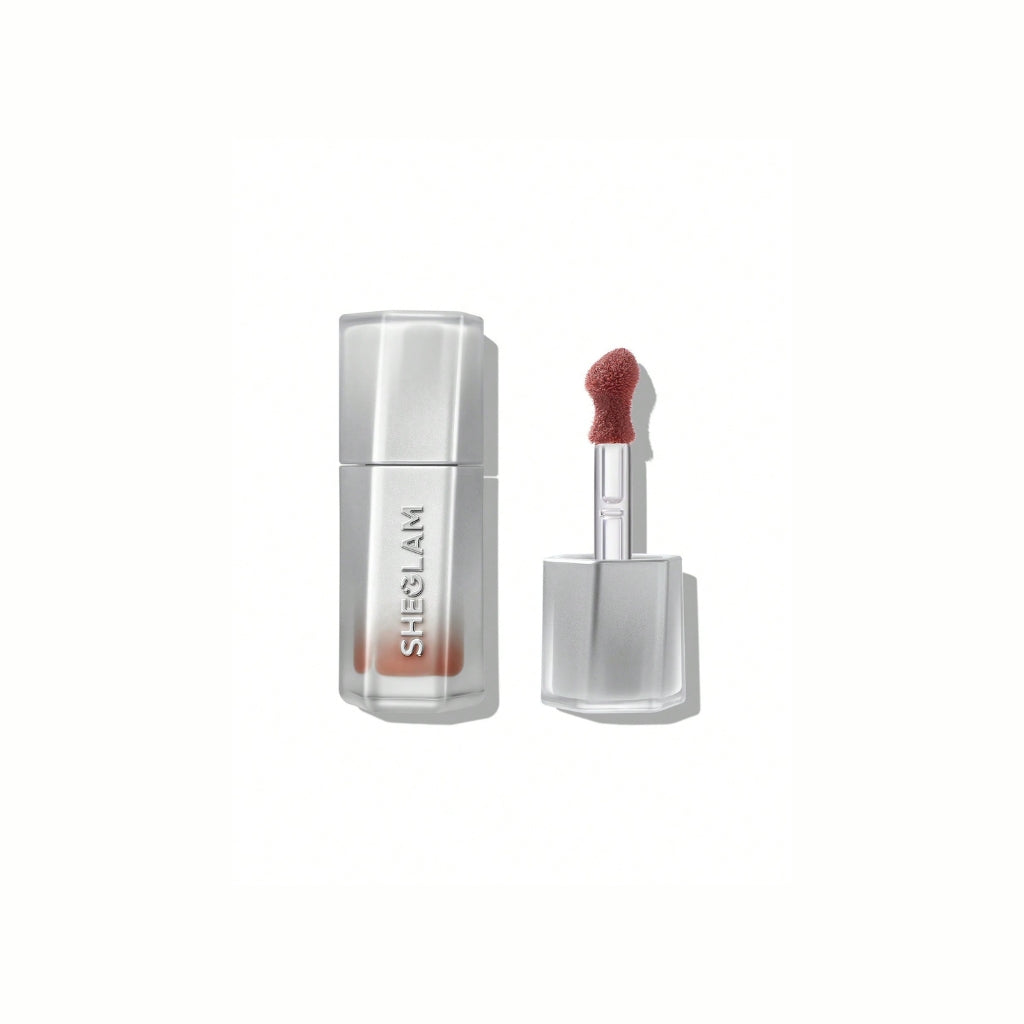SHEGLAM Glass Lock Air Gloss – Own It, fresh nude-rose high-shine lip gloss in a sleek tube with a glassy, mirror-like finish on a clean background.
