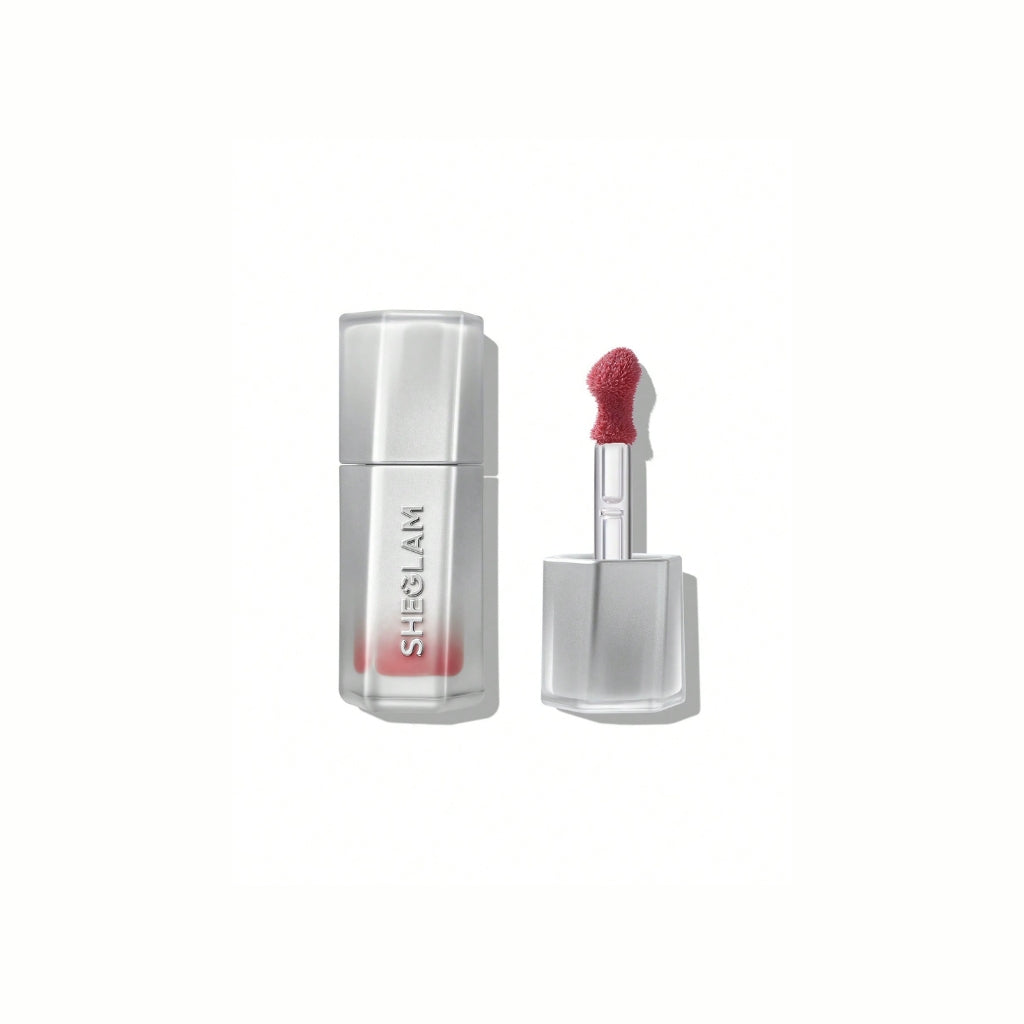 SHEGLAM Glass Lock Air Gloss – High Key, dusty mauve pink high-shine lip gloss in a sleek tube with a glassy, mirror-like finish on a clean background.
