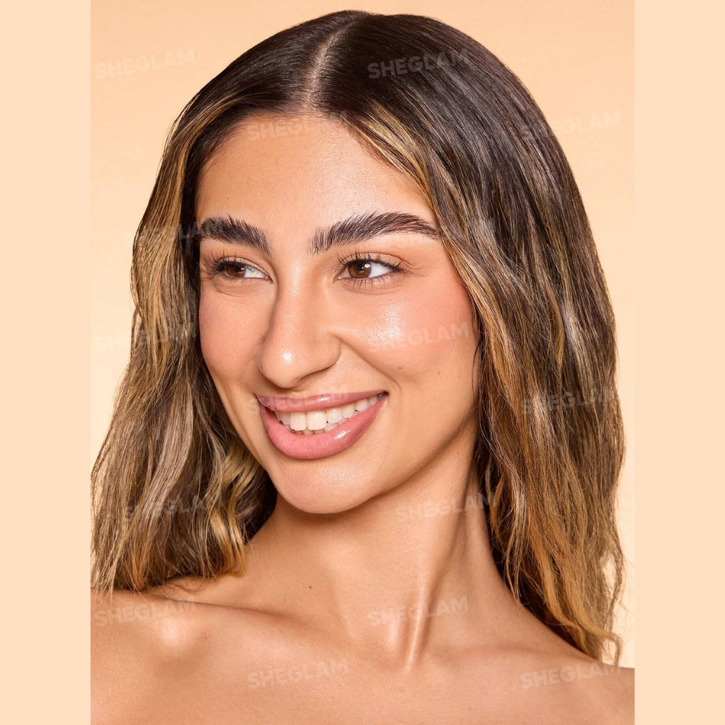 SHEGLAM Dew & Done Skin Tint with SPF20 in Nude shade, dewy light-to-medium coverage skin tint tube on a clean background.
