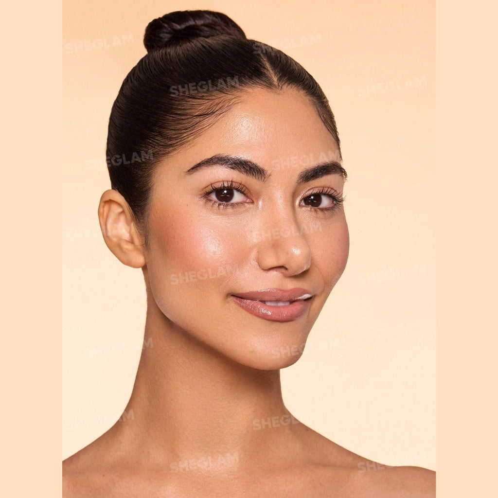 SHEGLAM Dew & Done Skin Tint with SPF20 in Acorn shade, dewy light-to-medium coverage skin tint tube on a clean background.
