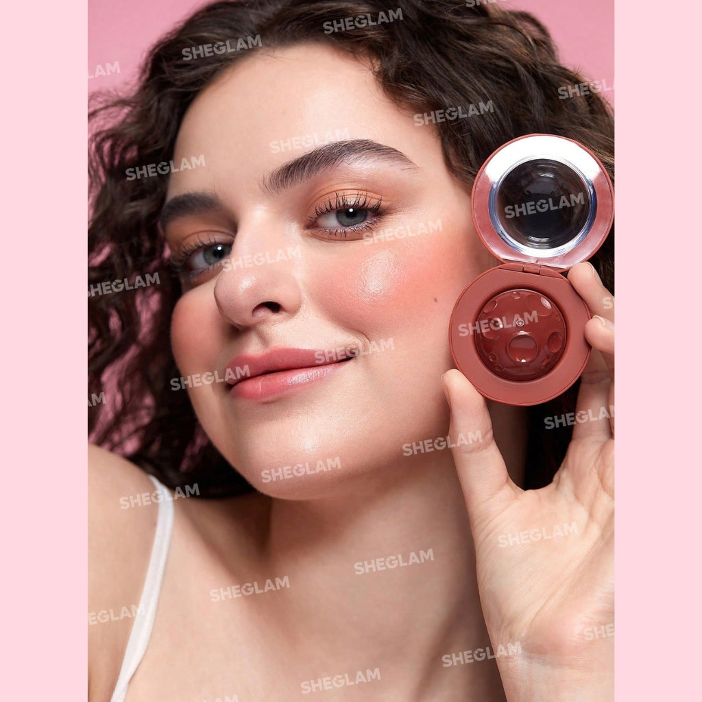 SHEGLAM Lunar Orbit Blush Ball in Astrid, hemispherical cream blush ball on a clean background.
