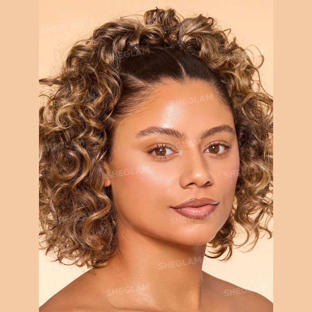 SHEGLAM Dew & Done Skin Tint with SPF20 in Almond shade, dewy light-to-medium coverage skin tint tube on a clean background.
